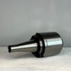 cnc tool holder in front of a off white background for sale